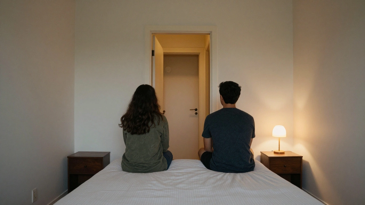 Two people sharing a bed centered in a room, both able to see the doorway from their sides, with a dim lamp casting gentle light and the door slightly ajar.